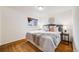 Cozy bedroom with hardwood floors, a window view, and a well-decorated bed with plush pillows at 2837 Reed St, Wheat Ridge, CO 80033