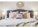 Close-up of a cozy bed in the main bedroom with decorative pillows and a stylish headboard at 2837 Reed St, Wheat Ridge, CO 80033