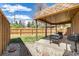 Cozy covered patio with a seating area overlooking the landscaped backyard at 2837 Reed St, Wheat Ridge, CO 80033
