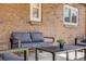 Cozy outdoor seating area with comfortable furniture on a brick patio at 2837 Reed St, Wheat Ridge, CO 80033