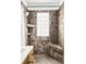 Bathroom featuring stone tiled shower and built-in shelving at 3365 S Grant St, Englewood, CO 80113