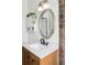 Bright bathroom featuring a wood vanity and an oval mirror at 3365 S Grant St, Englewood, CO 80113