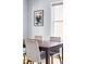 Close-up of the dining table and chairs in the dining room, with artwork on the wall at 3365 S Grant St, Englewood, CO 80113