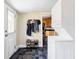 Entryway featuring stackable washer and dryer and a view into the kitchen at 3365 S Grant St, Englewood, CO 80113