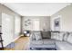 Bright living room with hardwood floors, neutral paint, and a comfortable gray sectional sofa at 3365 S Grant St, Englewood, CO 80113