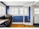 An office has light hardwood floors and navy walls with white trim at 3365 S Grant St, Englewood, CO 80113