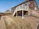 Backyard with a raised deck and stairs leading to a yard with grass and decorative rock at 4837 S Buchanan St, Aurora, CO 80016