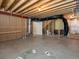 Unfinished basement space with exposed wood beams and concrete floors ready for customization at 4837 S Buchanan St, Aurora, CO 80016