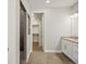 A bathroom vanity, tile floor, and an open doorway with a view of a walk-in shower at 4837 S Buchanan St, Aurora, CO 80016