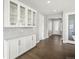 Hallway features glass display cabinets and an entryway into the space at 4837 S Buchanan St, Aurora, CO 80016