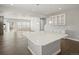 Bright, open-concept living room with hardwood floors, recessed lighting, and a kitchen island for entertaining at 4837 S Buchanan St, Aurora, CO 80016