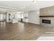 Spacious open floorplan with hardwood flooring, modern fireplace and updated kitchen with white cabinets at 4837 S Buchanan St, Aurora, CO 80016
