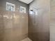 Custom tile shower with shower head and two windows for natural lighting at 4837 S Buchanan St, Aurora, CO 80016