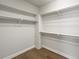 Walk-in closet featuring ample shelving and hardwood floors at 4837 S Buchanan St, Aurora, CO 80016