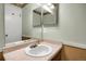 Bathroom featuring a white sink, large vanity mirror, and neutral wall color at 3853 S Genoa Ct # D, Aurora, CO 80013