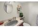 Bathroom features a round mirror, vanity, and storage shelves at 3853 S Genoa Ct # D, Aurora, CO 80013
