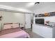 This bedroom has a clean aesthetic with a white dresser, television and decor at 3853 S Genoa Ct # D, Aurora, CO 80013