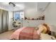 Cozy bedroom features a bright window display and comfortable furnishings at 3853 S Genoa Ct # D, Aurora, CO 80013