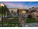 Inviting home featuring a well-maintained front yard, brick stairs, and a charming covered porch at 3853 S Genoa Ct # D, Aurora, CO 80013