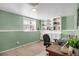 Functional home office with built-in shelving, ample storage, and a comfortable work space at 3853 S Genoa Ct # D, Aurora, CO 80013