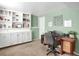 Home office with built-in shelving, a neutral color palette, and wood desk at 3853 S Genoa Ct # D, Aurora, CO 80013