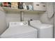 Laundry area includes a washer, dryer, and storage space at 3853 S Genoa Ct # D, Aurora, CO 80013