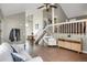 Bright living room featuring high ceilings, open staircase, and hardwood floors at 3853 S Genoa Ct # D, Aurora, CO 80013
