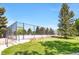 Outdoor tennis court showcasing durable fencing and easy access via nearby steps at 3853 S Genoa Ct # D, Aurora, CO 80013