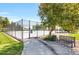 Outdoor tennis court featuring a sturdy fence and a nearby bench for resting after a game at 3853 S Genoa Ct # D, Aurora, CO 80013