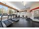 Well-equipped fitness center with treadmills, weight machines, and ample natural light at 9059 E Panorama Cir # B306, Englewood, CO 80112