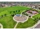 An aerial view of a community park with tennis and basketball courts plus playground area at 16048 Elizabeth St, Thornton, CO 80602
