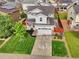 Aerial view of a home with well-manicured lawn, garden and a two-car garage at 16048 Elizabeth St, Thornton, CO 80602