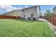 Expansive lawn, patio and privacy fence enclose the large backyard at 16048 Elizabeth St, Thornton, CO 80602
