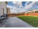 Fully fenced backyard with patio and trampoline on green grass at 16048 Elizabeth St, Thornton, CO 80602
