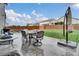 Outdoor patio with dining set, grill, and plenty of space for entertaining at 16048 Elizabeth St, Thornton, CO 80602