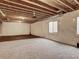 Spacious unfinished basement with open ceiling and carpet flooring at 16048 Elizabeth St, Thornton, CO 80602