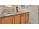 Bathroom vanity with double sinks, granite countertop, and wood cabinetry, providing ample storage space at 16048 Elizabeth St, Thornton, CO 80602