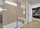 Contemporary glass shower with built in bench and a view into the bedroom beyond at 16048 Elizabeth St, Thornton, CO 80602