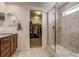 Bathroom featuring large shower, and granite vanity with ample counter space at 16048 Elizabeth St, Thornton, CO 80602