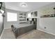 This bedroom features light gray walls, gray carpet, decorative shelving, a window, and a full-sized bed at 16048 Elizabeth St, Thornton, CO 80602