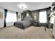 This bedroom features dark walls, carpet, large windows, a ceiling fan, and a full-sized bed with canopy at 16048 Elizabeth St, Thornton, CO 80602