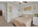 This bedroom features neutral walls, carpet, a ceiling fan, and a closet with white sliding doors at 16048 Elizabeth St, Thornton, CO 80602