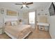 Cozy bedroom with carpet, ceiling fan and a bed with soft, peach-colored linens at 16048 Elizabeth St, Thornton, CO 80602