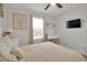 This bedroom features neutral walls, carpet, a ceiling fan, a TV mounted on the wall, and a window with blinds at 16048 Elizabeth St, Thornton, CO 80602
