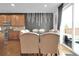 Elegant dining space with designer accent wall, table seating, and sliding door leading to the backyard at 16048 Elizabeth St, Thornton, CO 80602