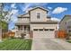 Charming two-story home featuring a well-manicured lawn, neutral siding, and a two car garage at 16048 Elizabeth St, Thornton, CO 80602