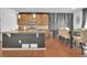 Open kitchen with an island, dining table, and stainless steel appliances at 16048 Elizabeth St, Thornton, CO 80602