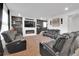 Bright living room with modern sofas, fireplace, and wall decor at 16048 Elizabeth St, Thornton, CO 80602