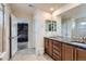 Spacious main bathroom featuring a double vanity, granite countertops, and a separate shower at 16048 Elizabeth St, Thornton, CO 80602