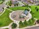 Aerial view of a community park, featuring playgrounds, covered picnic area and walking paths at 16048 Elizabeth St, Thornton, CO 80602